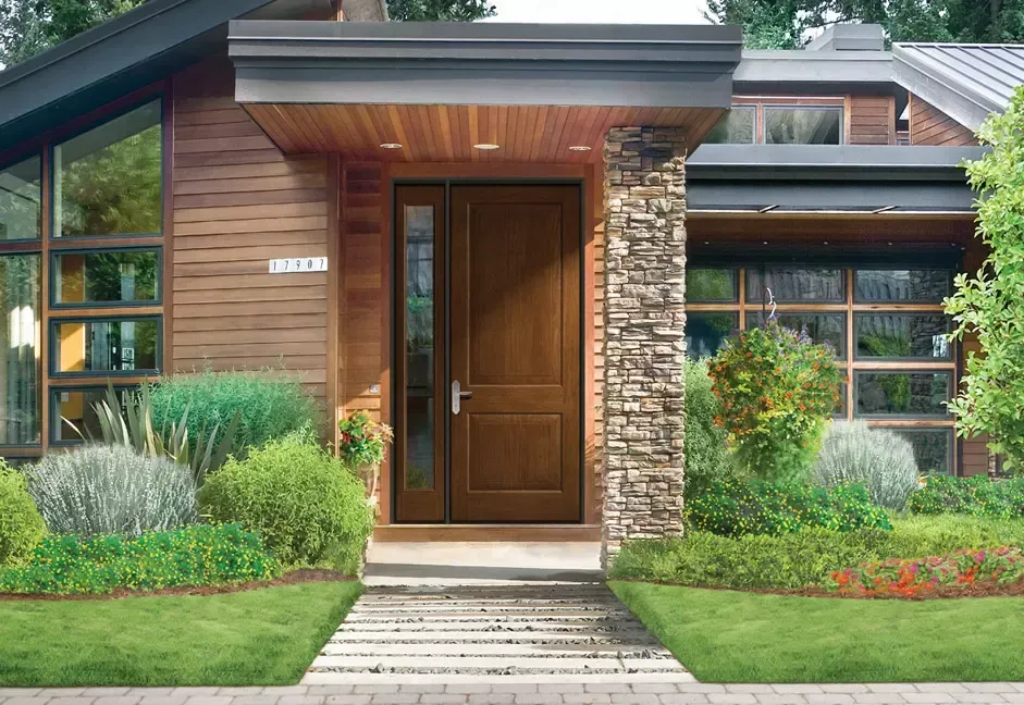 A modern house with a wooden door and a stone wall.