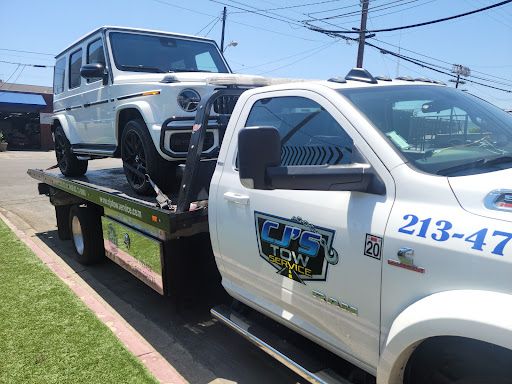 A jeep is being towed by a tow truck.