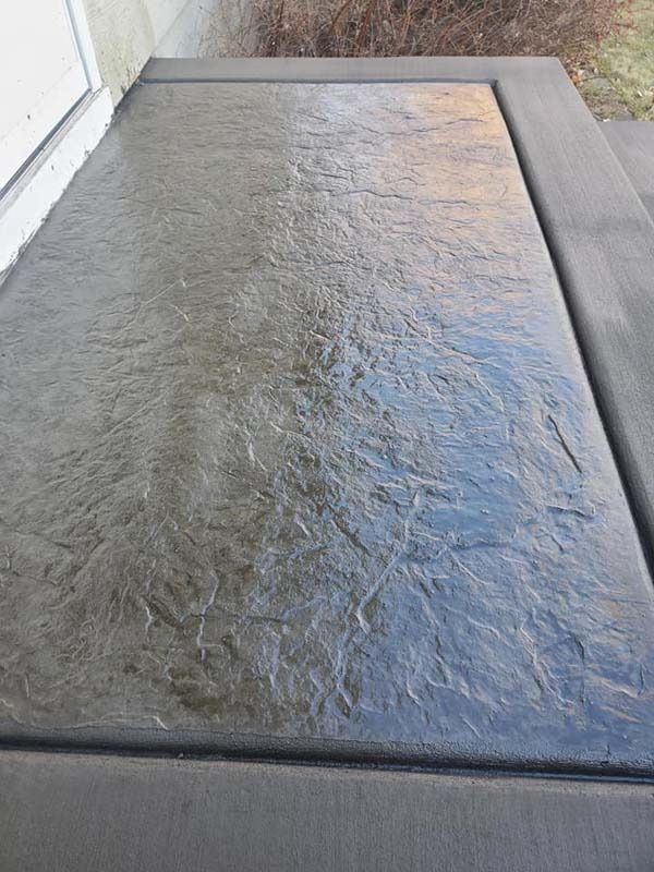 A close up of a concrete floor next to a door.