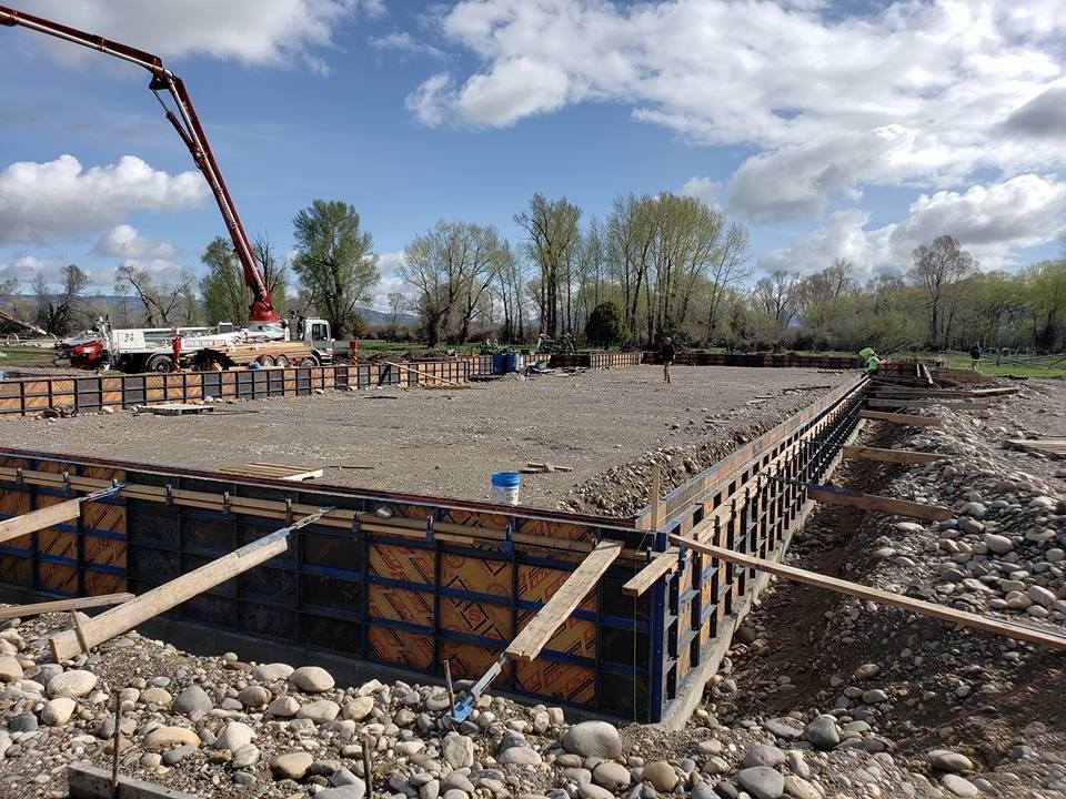 A construction site with a concrete pump in the background.