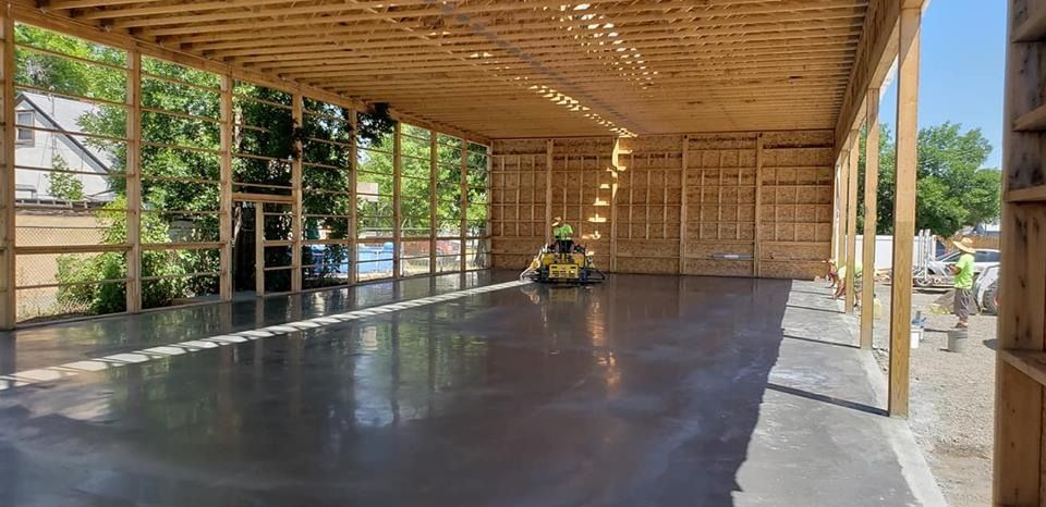 A large concrete floor in a building under construction.