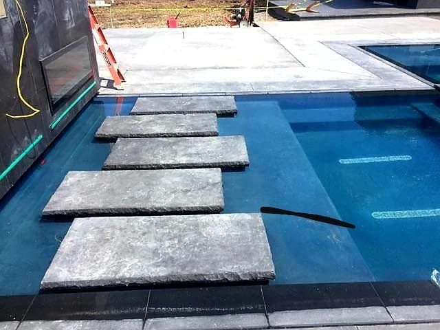 A swimming pool with steps leading up to it