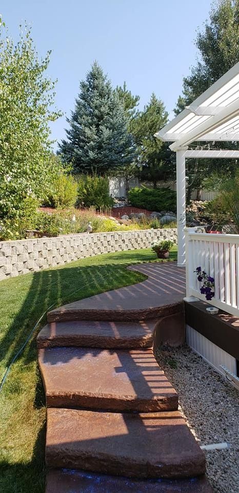 There are stairs leading up to a gazebo in the backyard.
