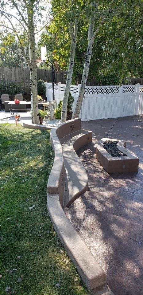 There is a fire pit in the middle of the backyard.