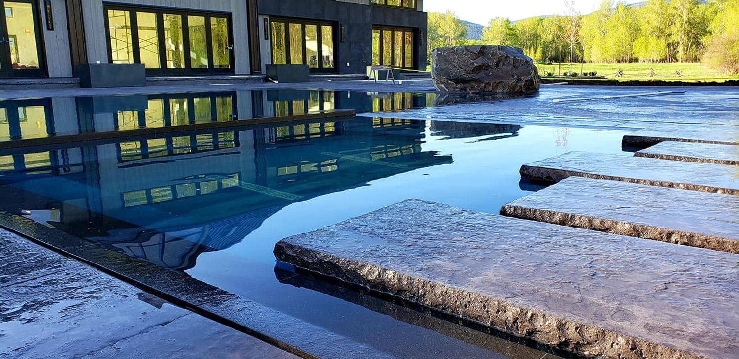 A building is reflected in a puddle of water.