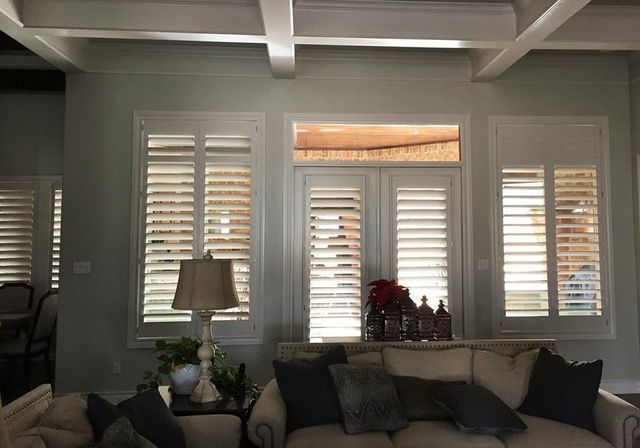 A Living Room With A Couch, Lamp, And Shutters On The Windows – Lubbock, TX – Wilson Blind & Shutter