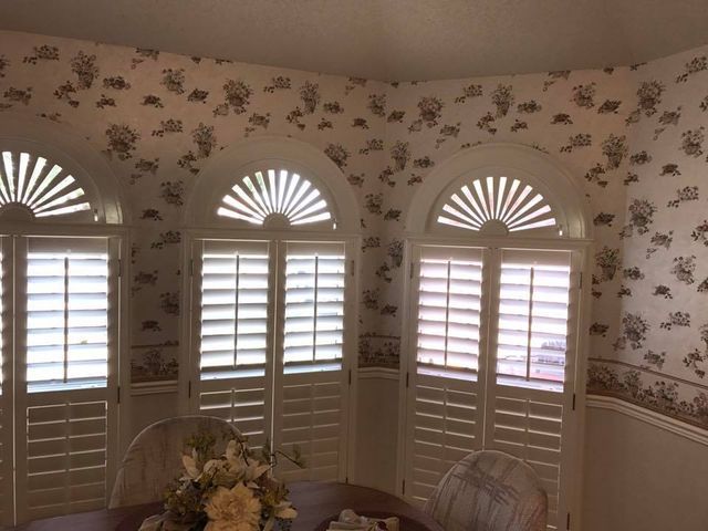 A Dining Room With Arched Shutters And Floral Wallpaper – Lubbock, TX – Wilson Blind & Shutter
