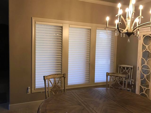 A Dining Room With A Table And Chairs And A Chandelier – Lubbock, TX – Wilson Blind & Shutter