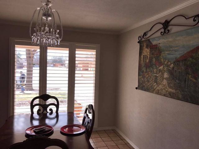 A Dining Room With A Table, Chair, And Blinds – Lubbock, TX – Wilson Blind & Shutter