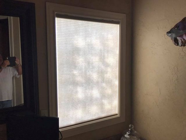 A Person Is Taking A Picture Of A Window With Blinds – Lubbock, TX – Wilson Blind & Shutter
