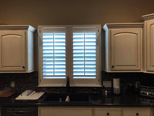 A Kitchen With A Sink, Cabinets, And Shutters On The Windows – Lubbock, TX – Wilson Blind & Shutter