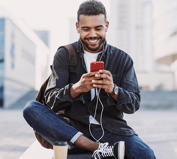 Smiling man looking at smartphone