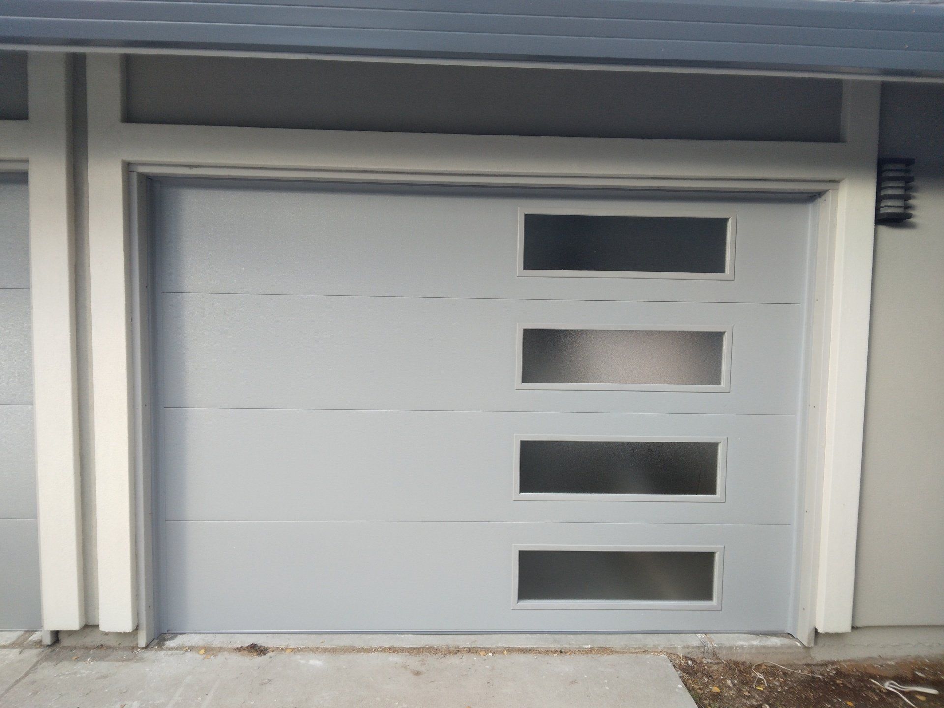 The right side of a double glass garage door installation in the Greater Bay area by Garage Door Excellence