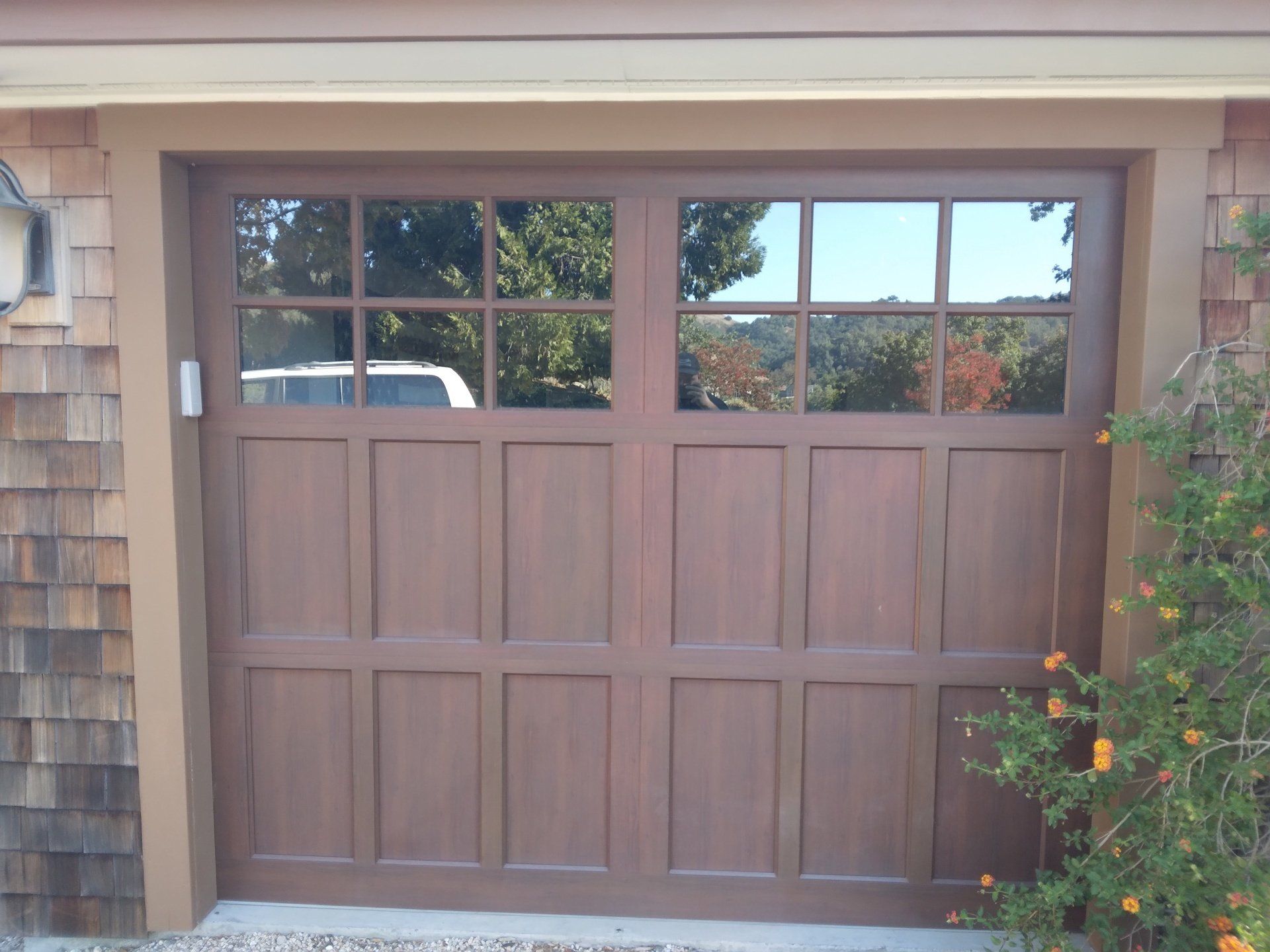 A wooden garage door being serviced by Garage Door Excellence in Fairfield, CA