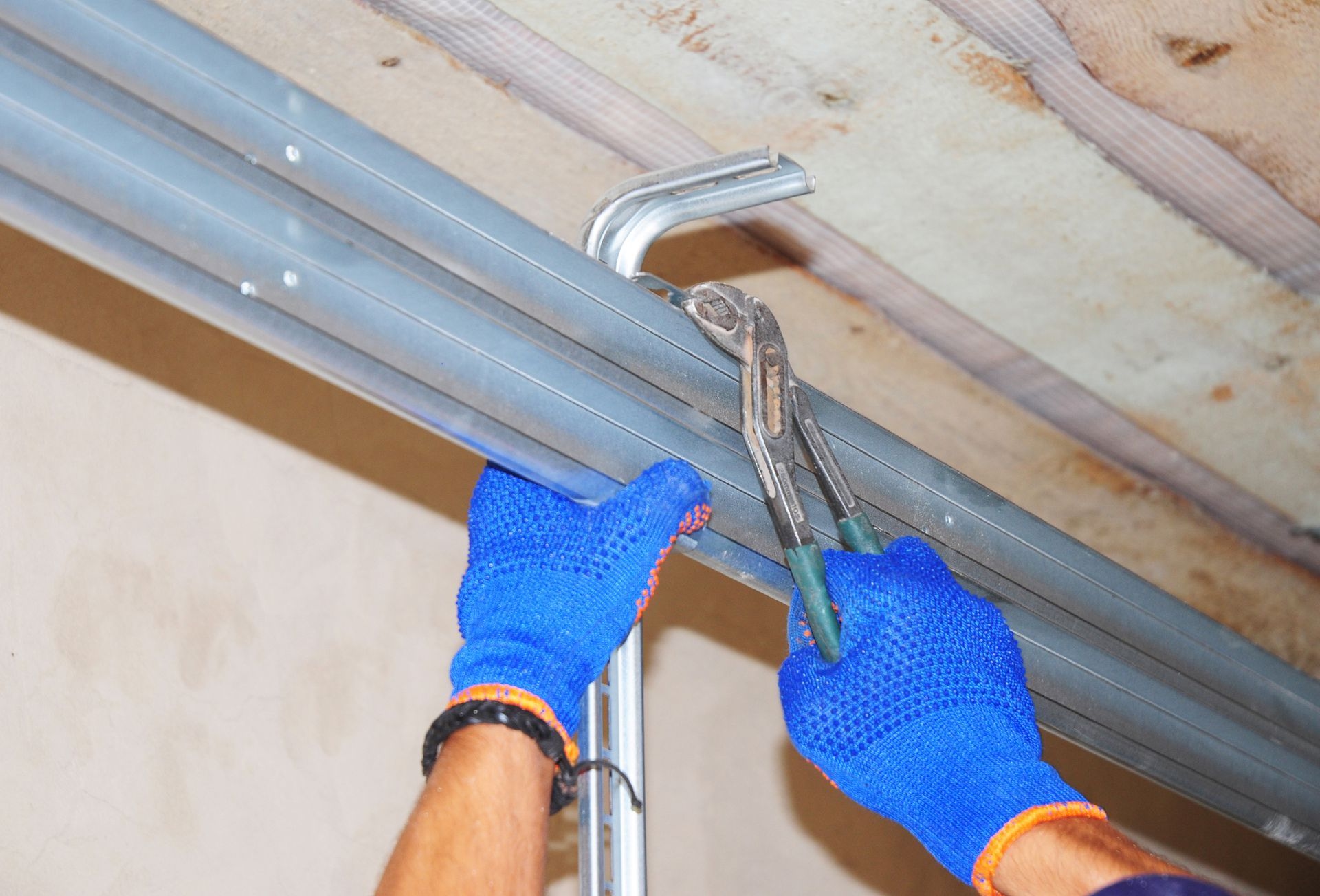 A garage door being fixed by Norman Garage Door.