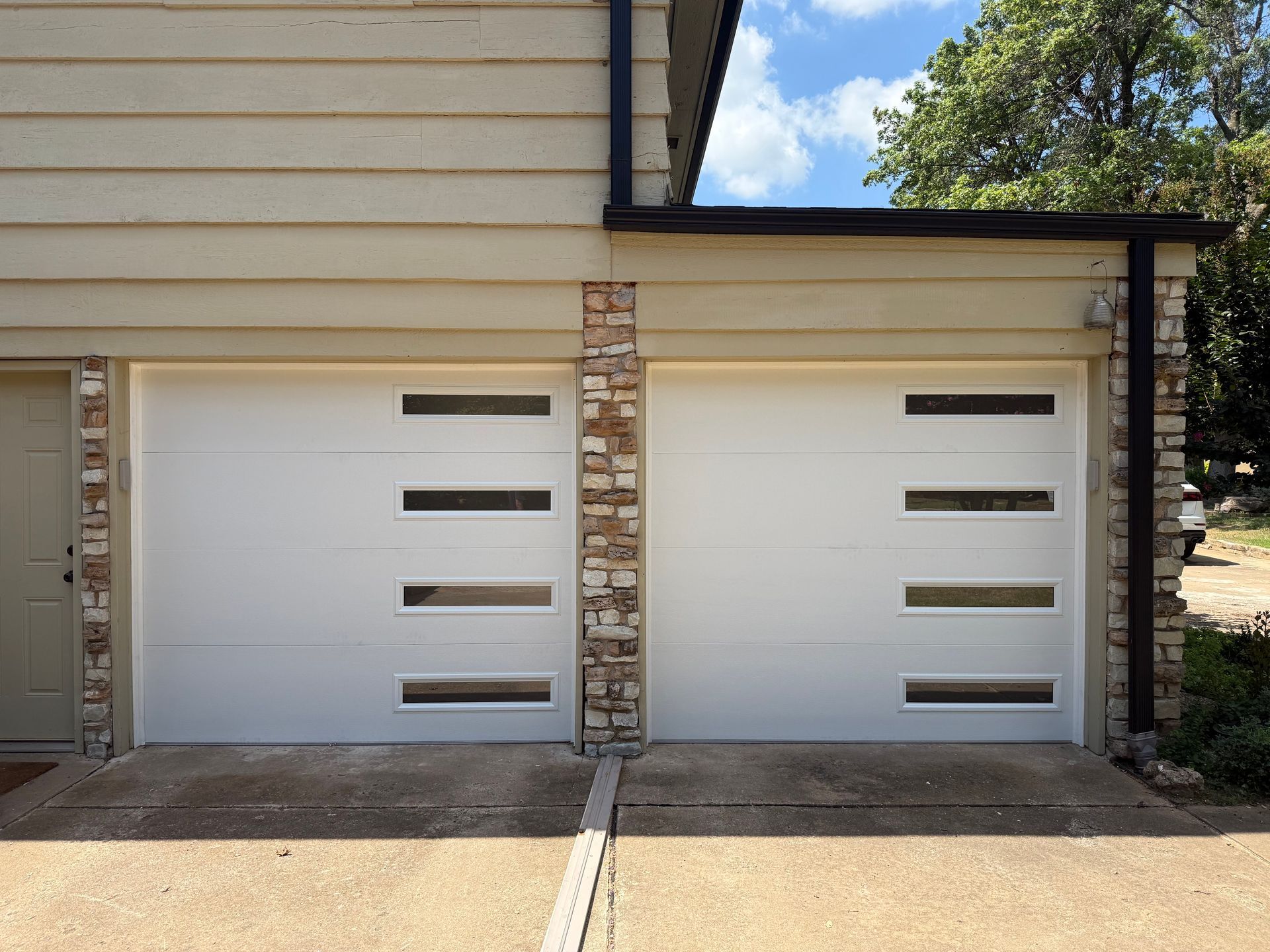 Two garage doors installed by Norman Garage Door.