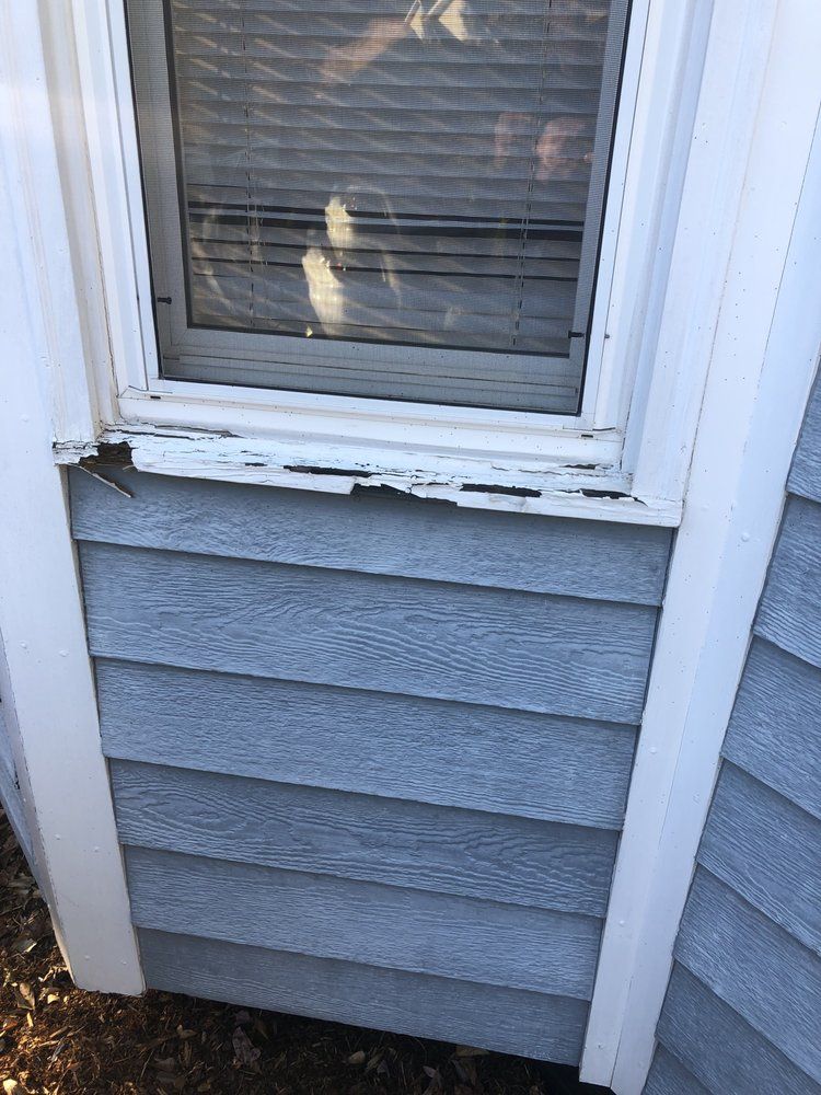 A close up of a window on the side of a house.