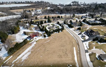 An aerial view of a residential area with snow on the ground