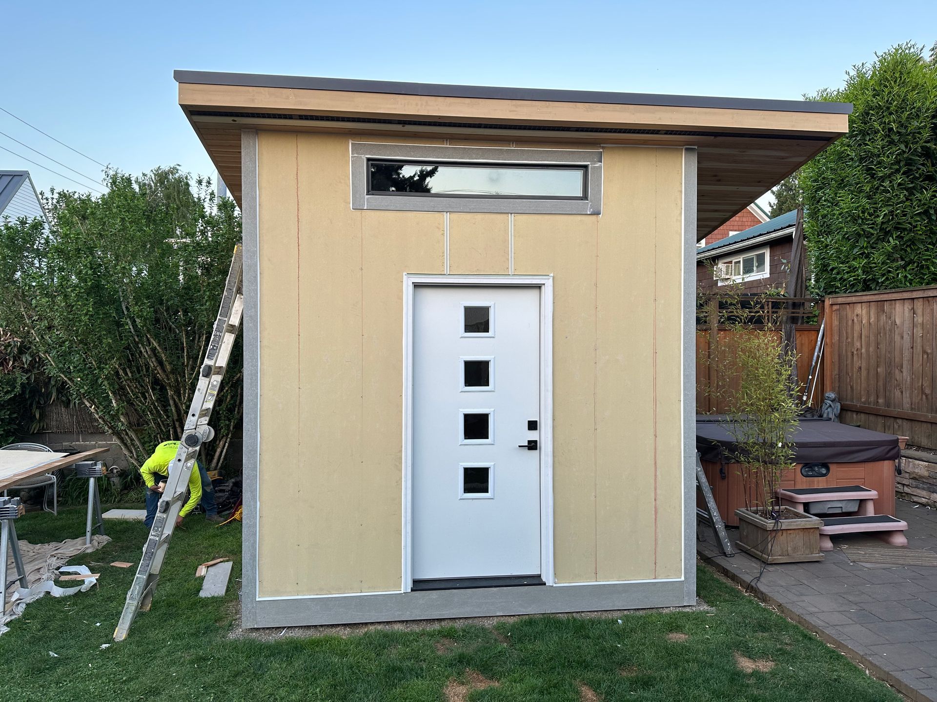 A small shed with a white door and a window