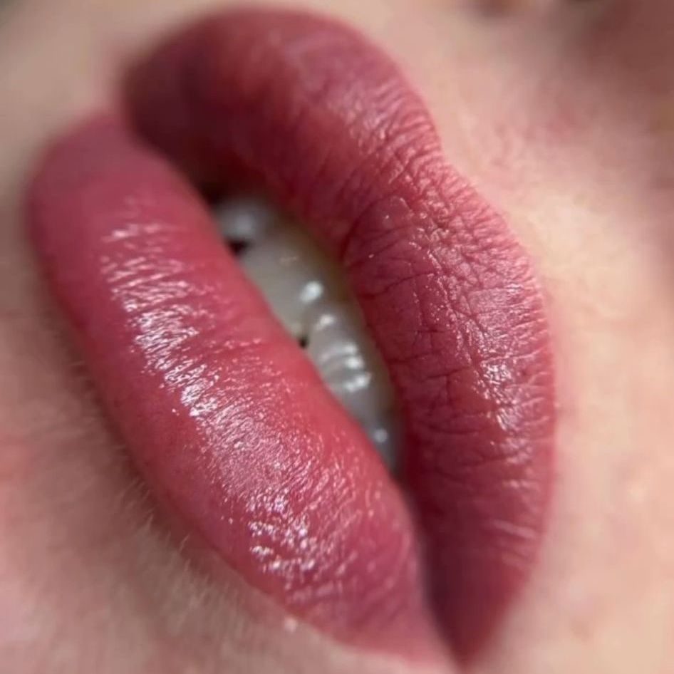 a close up of a woman 's lips with red lipstick .
