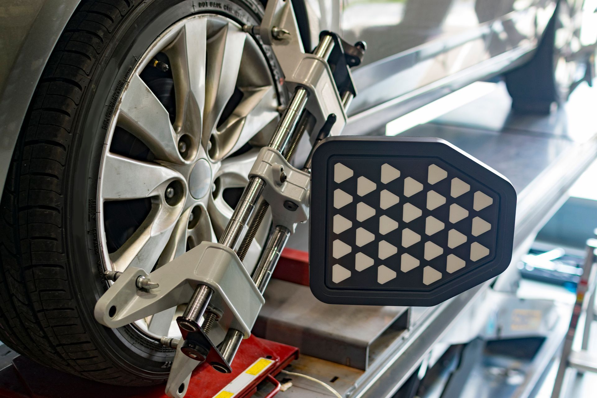 A car is being aligned with a machine in a garage.