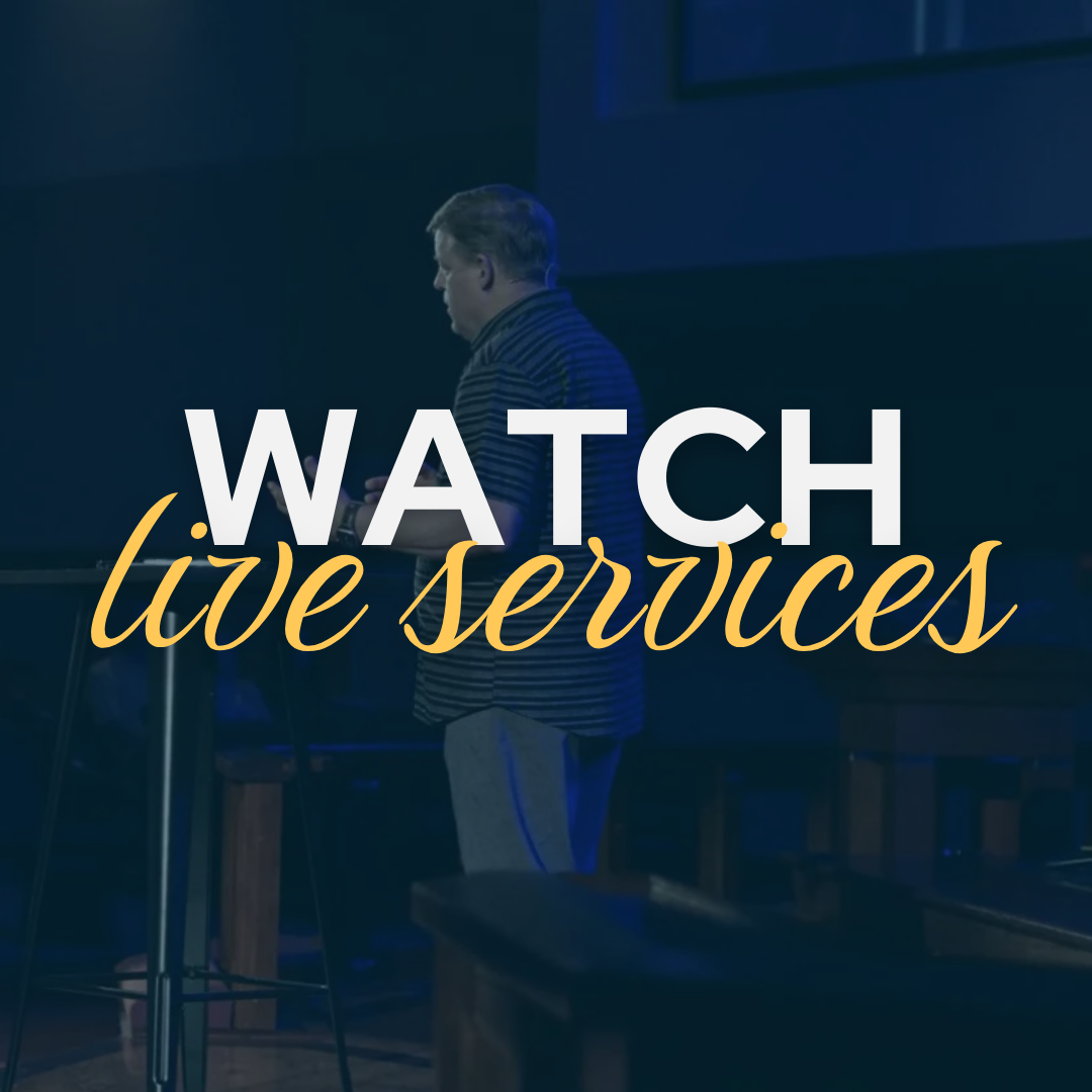 A man is standing in front of a sign that says watch live services.