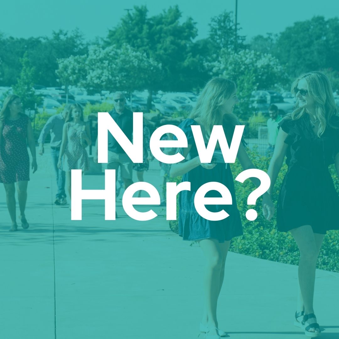 A group of people walking down a sidewalk with the words `` new here '' written on it.