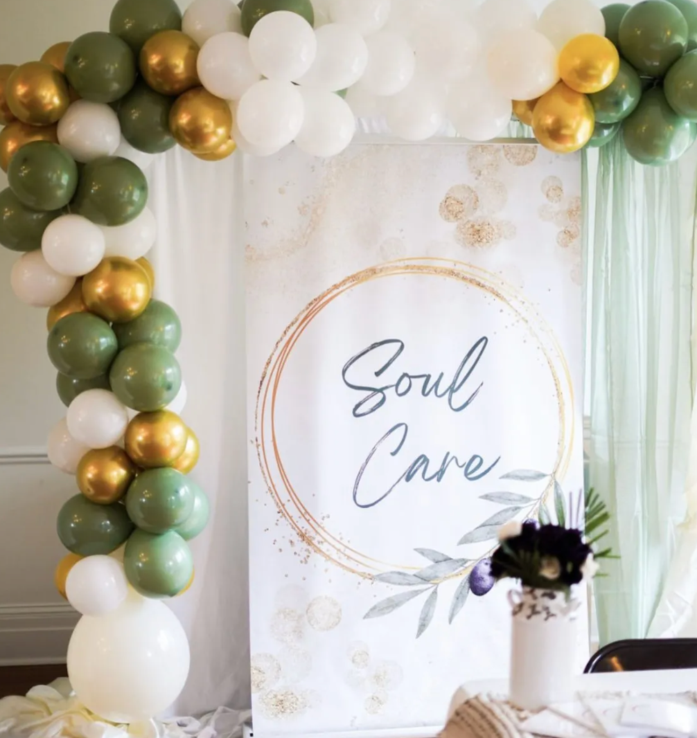 A sign that says soul care is surrounded by balloons