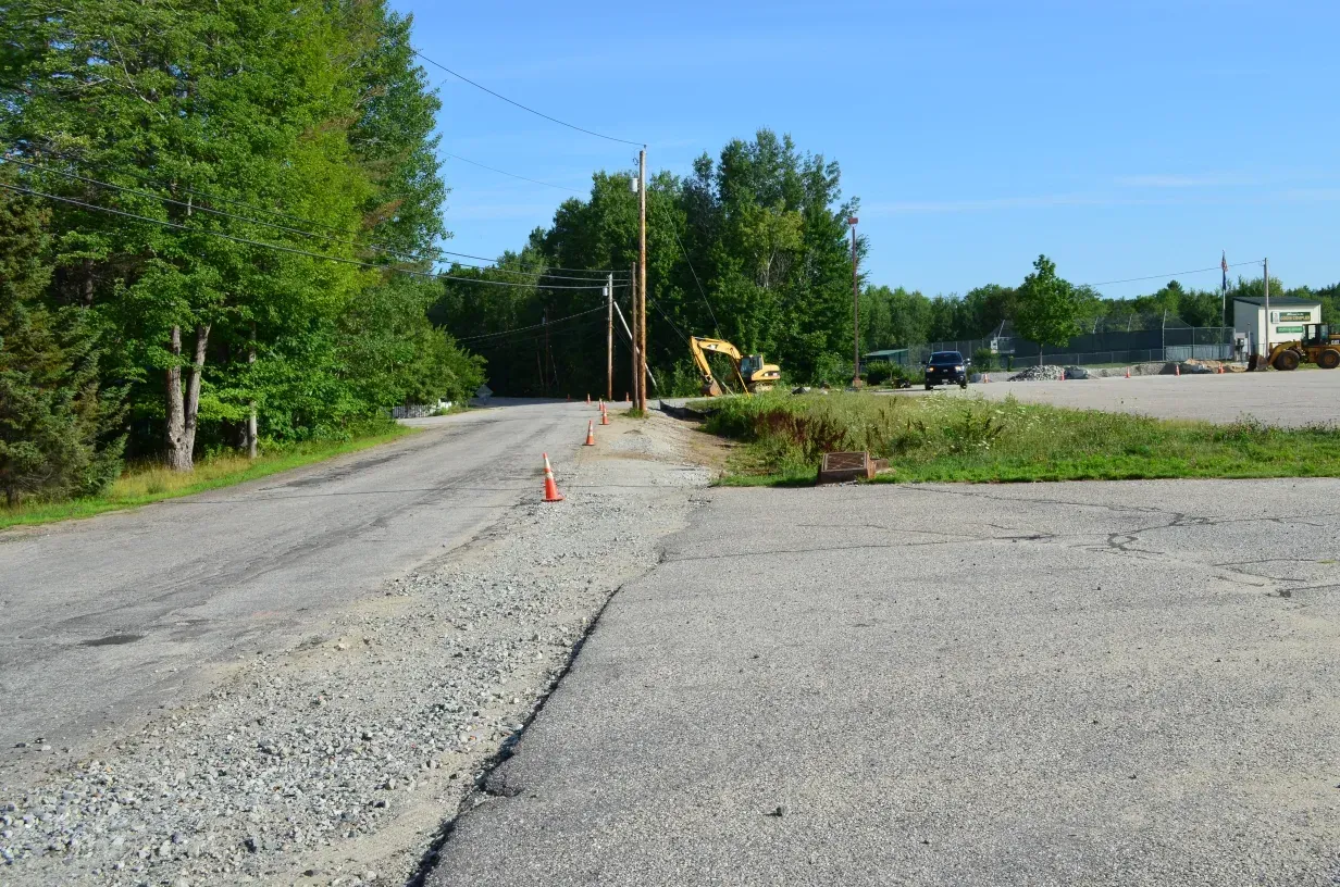 A road with a lot of trees on the side of it.