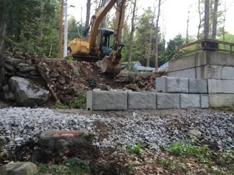 A bulldozer is digging a hole in a rocky area.