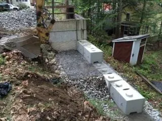 A construction site with a bulldozer and concrete blocks.