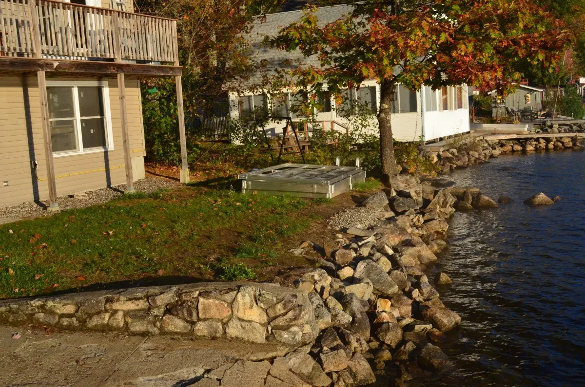 A house sits on the shore of a lake