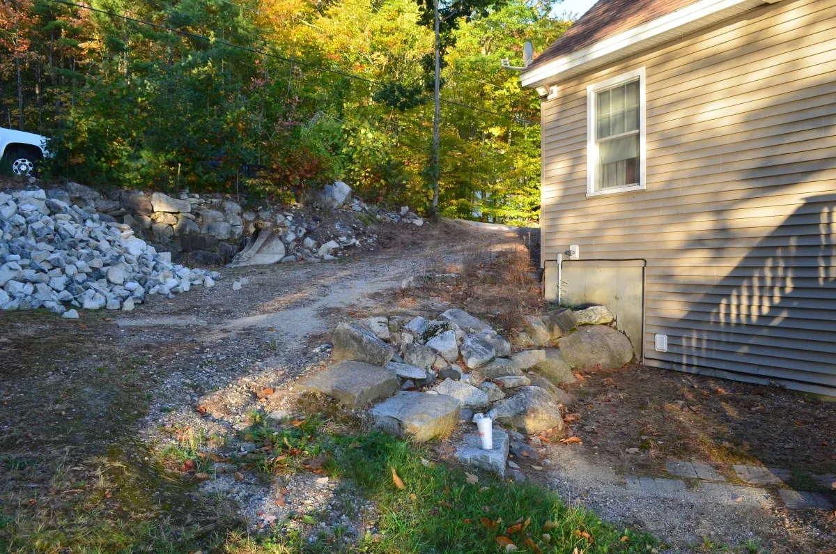 A house with a lot of rocks in front of it