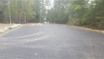 A blurred image of a road with trees on the side of it.