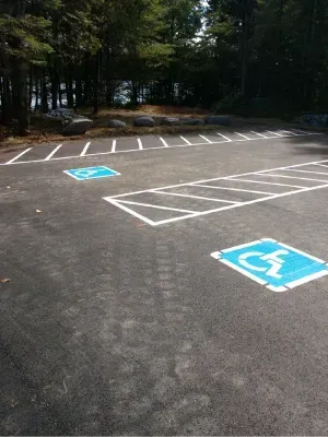 A parking lot with a handicap sign painted on the ground