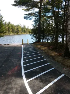 A parking lot with a lake in the background