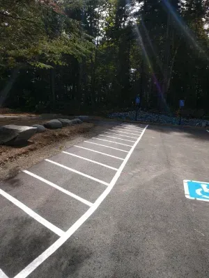 A parking lot with a handicap sign painted on the side of it.