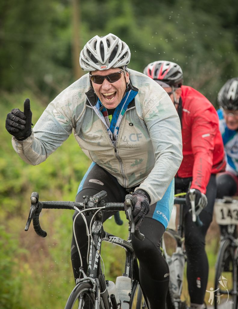 Man on his bike giving a thumbs up.