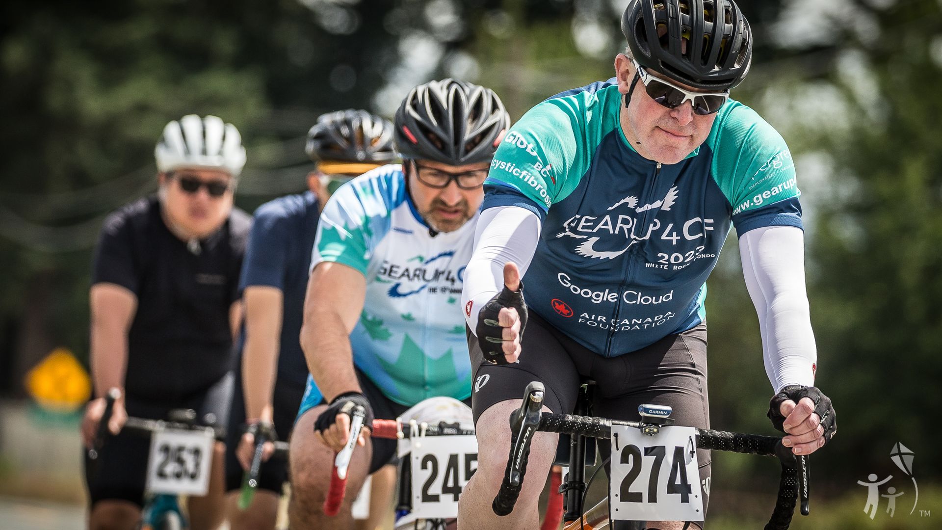 Bikers on their bike riding one giving a thumbs up.