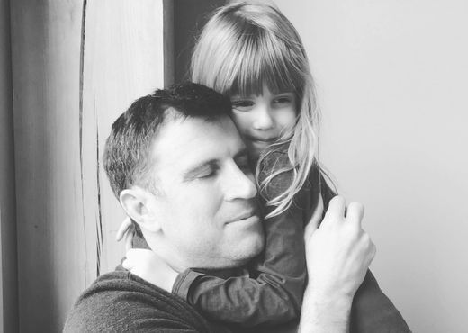 Aaron hugs his daughter who has CF - black and white photo. 
