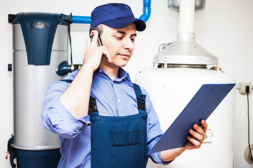 Technician Servicing Water Heater — Plumbing in Lismore, NSW