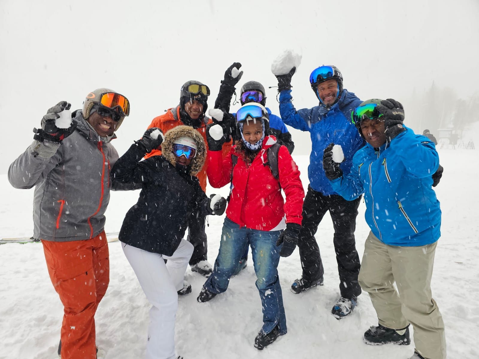 A group of people are posing for a picture in the snow.