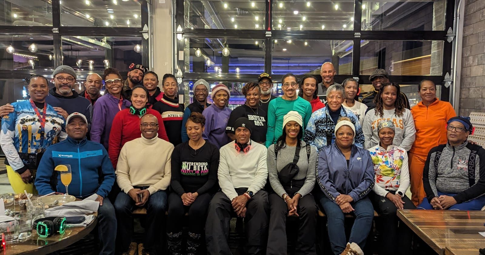 A large group of people are posing for a picture in a room.