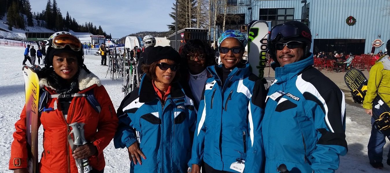 A group of people are posing for a picture in the snow.