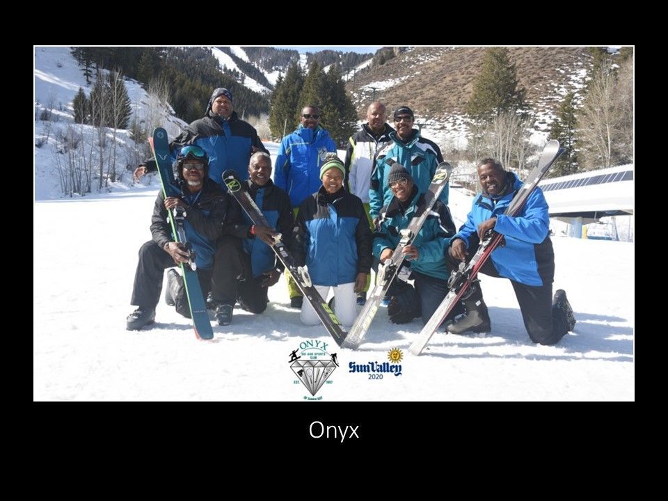 A group of skiers posing for a picture with the word onyx at the bottom