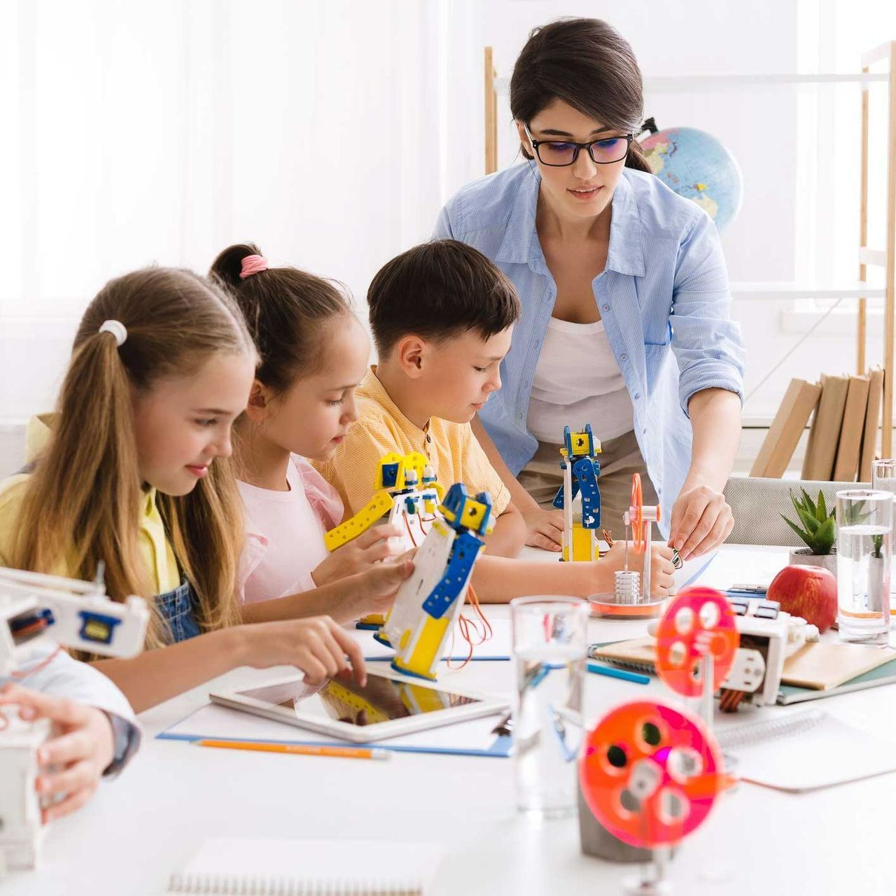 Teacher Helping Children with Their Robots — Panama City Beach, FL — Eselin Educational Services