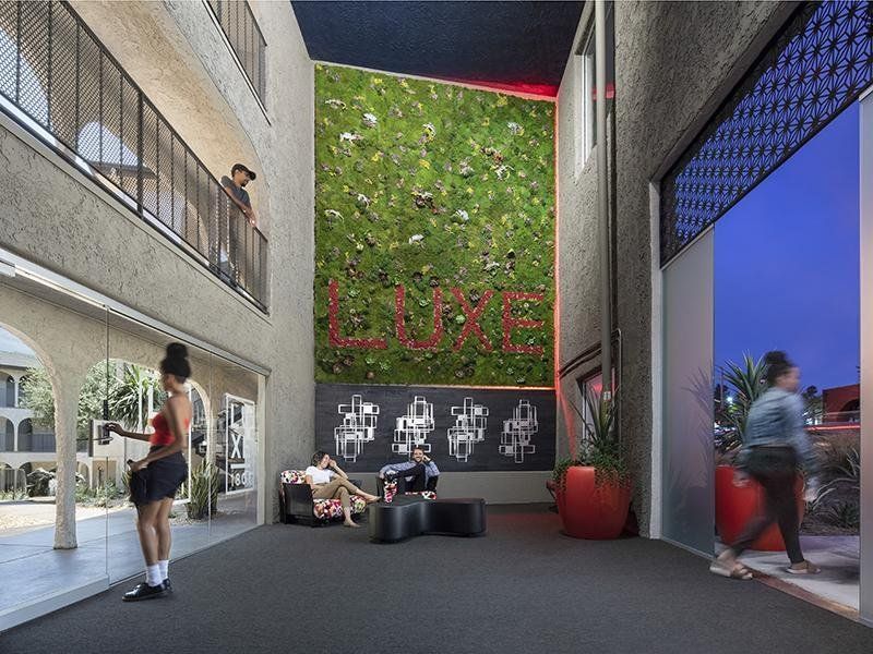 An artist 's impression of a building with a green wall