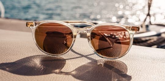 A pair of sunglasses is sitting on a table.