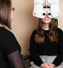 A woman is getting her eyes checked by an ophthalmologist