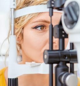 A woman is getting her eyes examined by an ophthalmologist.